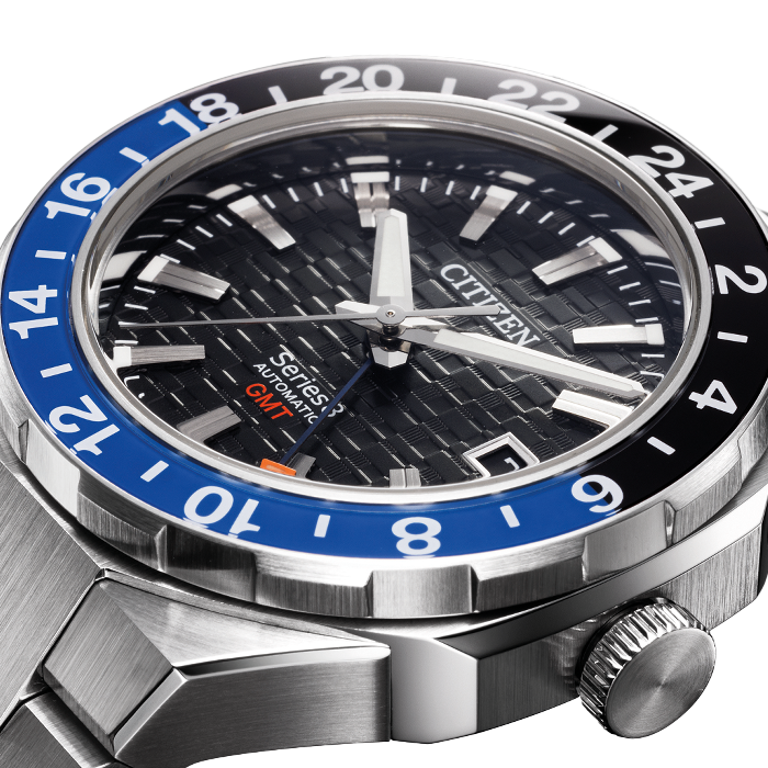 Citizen horloge met blauw en zwarte bezel, GMT-functie en zwarte wijzerplaat.