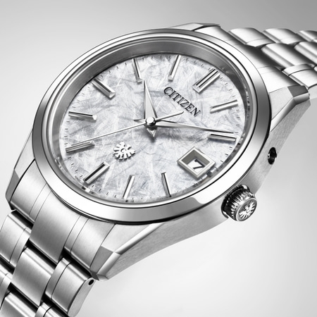 Citizen-Uhr mit silbernem Armband und strukturierter Oberfläche, Datumsanzeige.