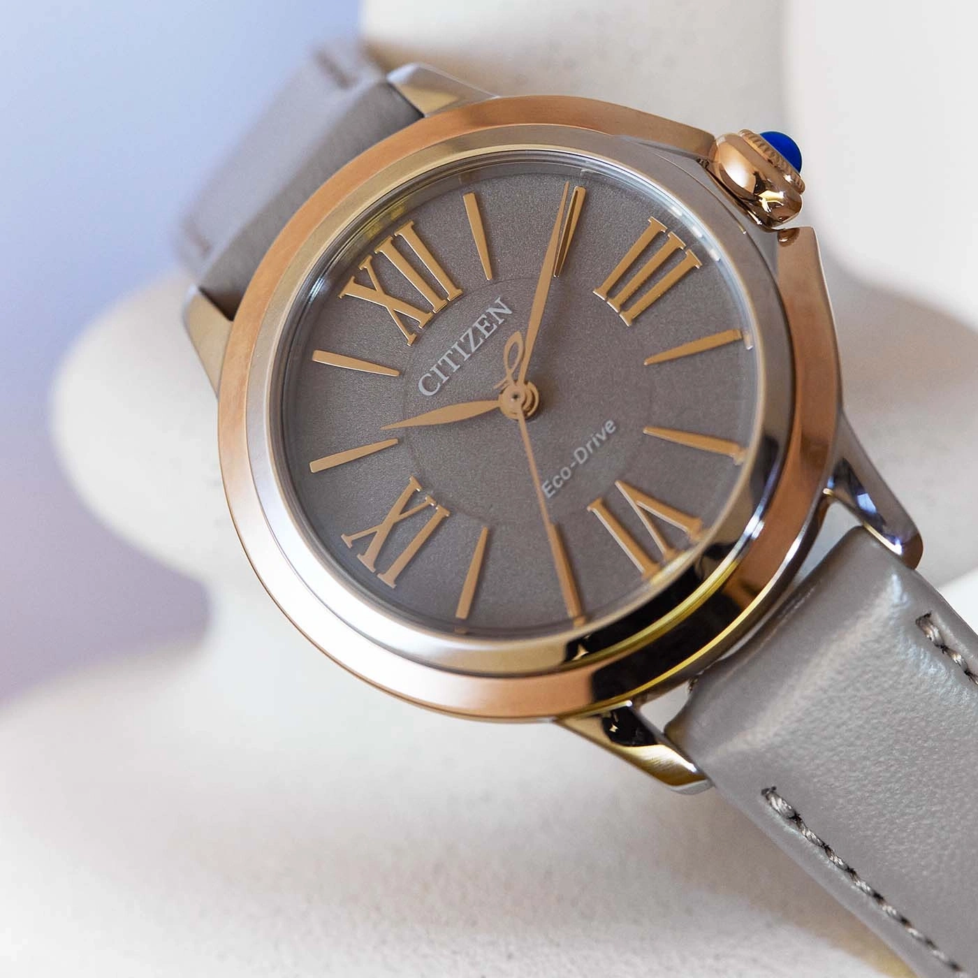 Citizen Eco-Drive horloge met grijze wijzerplaat en leren band, gouden accenten.