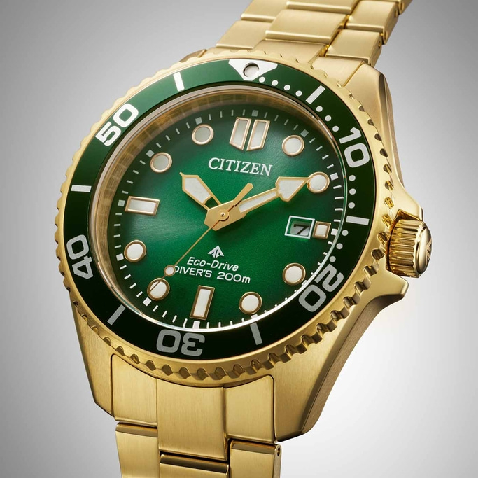 Gouden Citizen horloge met groene wijzerplaat en bezel, close-up.