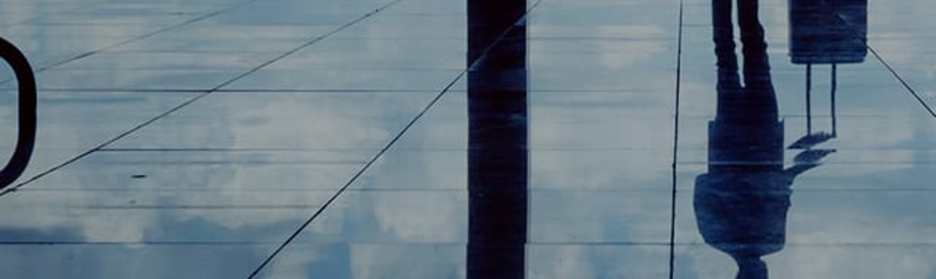 Reflectie van een persoon op glas, abstract en artistiek.