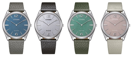 Vier Citizen horloges met verschillende gekleurde wijzerplaten en leren bandjes, elegant design.