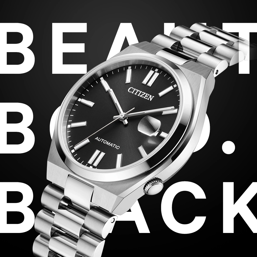 A close-up of a Citizen automatic watch with a silver band and black dial, set against a black background with white text "BEAUT BACK".
